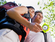 Couple with backpacks looking at compass
