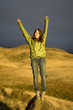 Happy teen girl with raised arms