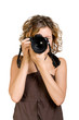 Young beautiful woman taking a photo with a camera