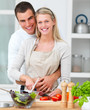 Happy couple  preparing food in the kitchen