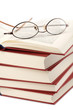 pile of books with glasses isolated