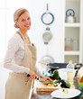 Young beautiful lady cutting vegetables in the kitchen Young beautiful lady cutting vegetables in the kitchen