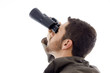 side view of hispanic man looking through binoculars side view of hispanic man looking through binoculars