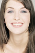 Young Woman face with make up, smiling, looking at he camera, close-up (studio)