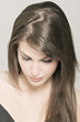 Young Woman face with make up, bended head,  strasses on her eyelids (studio)