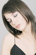 Young Woman face with make up, bended head,  strasses on her shut eyelids (studio)