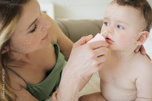 Photo: Mother wiping baby's nose Mother wiping baby's nose