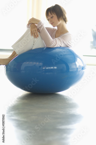 Photo: Young woman resting in blue armchair Young woman resting in blue armchair