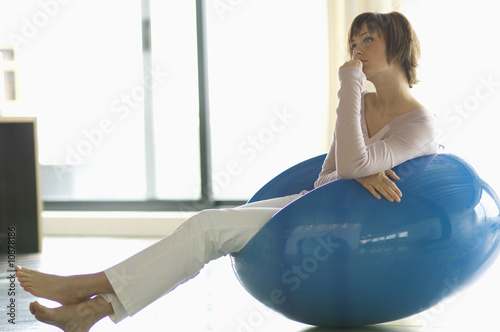 Photo: Young woman resting in blue armchair Young woman resting in blue armchair