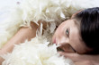 Foto: Young woman with white feather boa Young woman with white feather boa