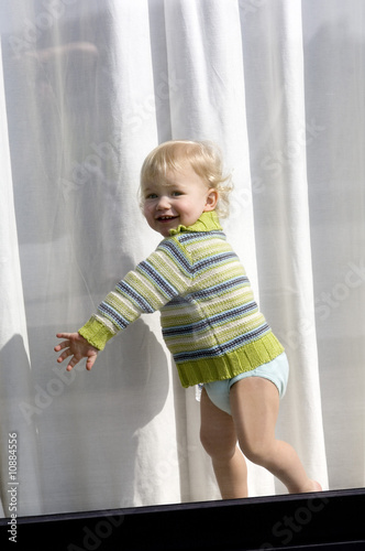 Photo: Little boy standing behind window Little boy standing behind window