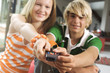 Teenage boy and girl using remote control