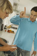 Father and teenager listening to MP3 player, indoors