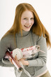 Portrait of a young woman holding rolls of wrapping papers and smiling