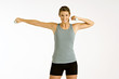 Portrait of a young woman exercising with dumbbells