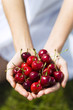 Young woman holding cherries