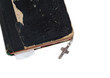 silver cross on old bible with leather cover