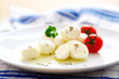 Pieces of mozzarella cheese and tomato