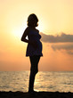 Pregnant woman at sunset