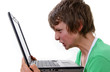 Boy looking angry whilst holding computer Boy looking angry whilst holding computer