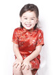 Eurasian girl smiling in red cheongsam