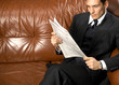 man reads newspaper