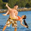 Boyfriend lifting girlfriend on beach