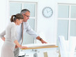 Architect and client looking at plans