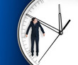 Businessman hangs on an arrow of clock