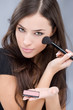 young pretty girl holding powder brush young pretty girl holding powder brush