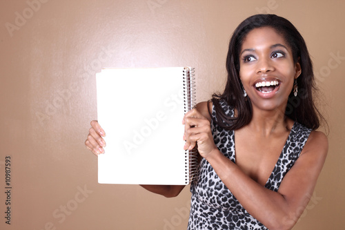 Photo: Woman holding a blank notebook Woman holding a blank notebook