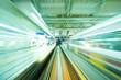 Speedy trains passing train station. Focus on the rail road.