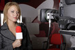 serious TV reporter in live transmission lookin at camera