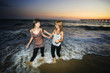Photo: Two beautiful girls on ocean beach at sunset. Two beautiful girls on ocean beach at sunset.