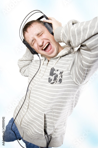 Photo: The young man listens to music The young man listens to music