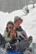 Teens sledding on a saucer