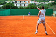 Man plays tennis outdoors