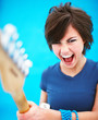 Excited woman playing guitar with copyspace