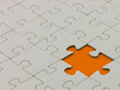 Incomplete white puzzle with a missing orange piece