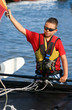 Photo: enfant tendant la voile de son catamaran enfant tendant la voile de son catamaran