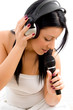 top view of female holding headphone and microphone against whit