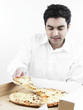 portrait of a smart looking asian man eating pizza