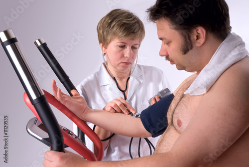 man is being observed by doctor after training