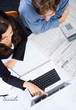 businesswoman pointing at laptop screen with a collegue