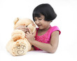 portrait of an asian girl with her pink teddy bear
