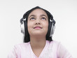 an asian teenage girl of indian origin listening to music