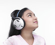 asian teenage girl of indian origin listening to music