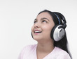 an asian teenage girl of indian origin listening to music