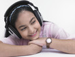 an asian teenage girl of indian origin listening to music