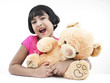 portrait of an asian girl with her brown teddy bear
